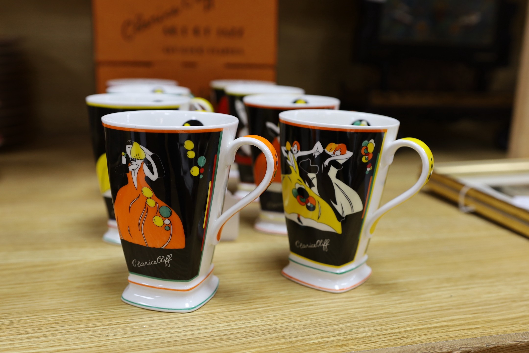 Eight Clarice Cliff limited edition ‘Age of Jazz’ mugs - Charleston, Fascinating Rhythm, Strike Up The Band, Putting On The Ritz, High Society, On The Town, Cheek To Cheek and Shall We Dance. 12cm tall, boxed.